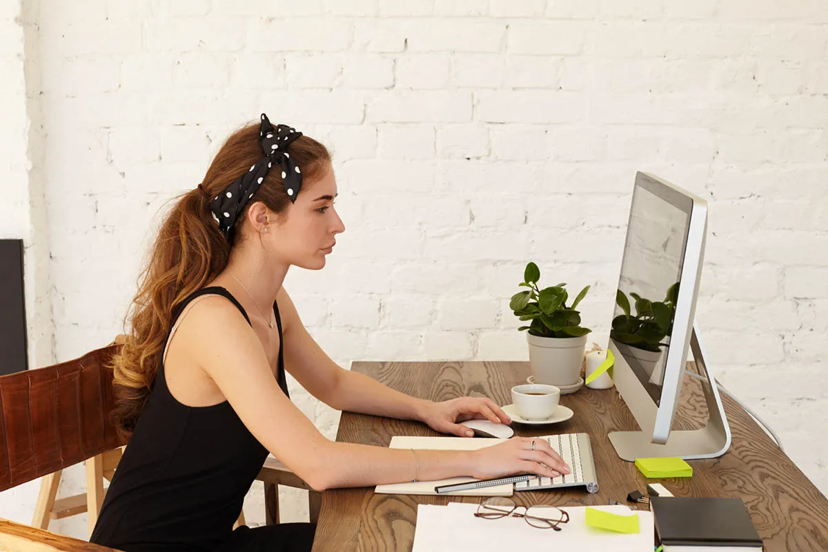 Standing-height desk partition softened by drapes
